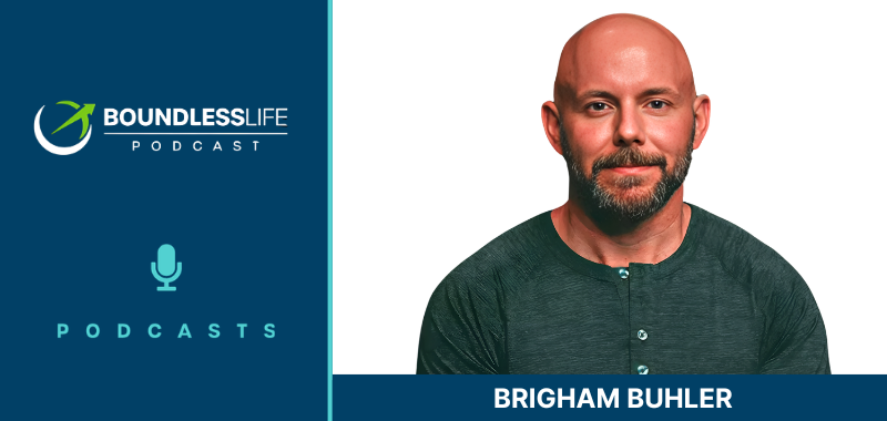 Boundless Life Podcast guest graphic featuring Brigham Buhler. The left side has a dark navy blue background displaying the circular Boundless Life Podcast logo with a stylized athlete figure, the text "Boundless Life Podcast" in white, and a teal microphone icon labeled "Podcasts" beneath it. The right side shows a professional headshot of Brigham Buhler, a bald man with a neatly trimmed dark beard, wearing a dark teal henley shirt with button placket detail, against a clean white background. He is looking directly at the camera with a composed expression