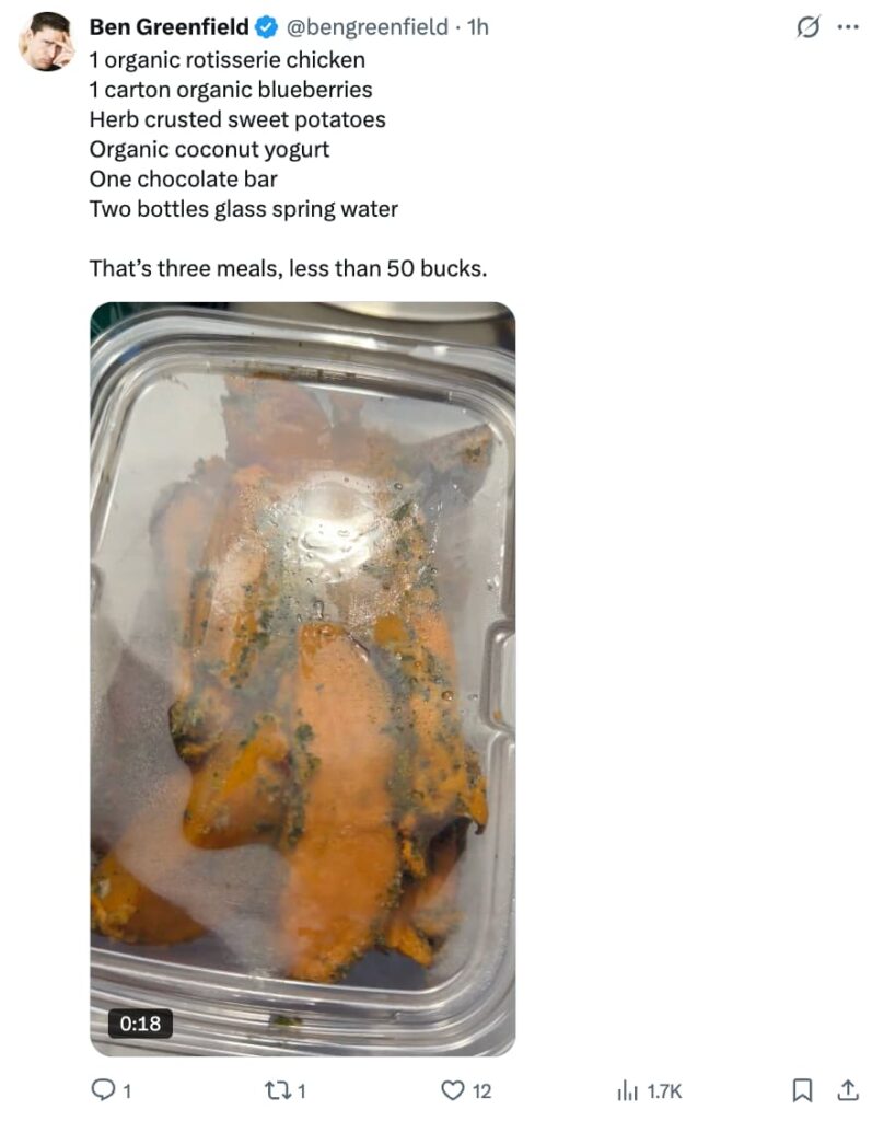 Screenshot of a tweet from @bengreenfield listing a budget-friendly whole foods grocery haul — organic rotisserie chicken, blueberries, herb crusted sweet potatoes, coconut yogurt, a chocolate bar, and glass spring water — for under $50, accompanied by a video thumbnail of a herb-seasoned rotisserie chicken in a clear plastic container.