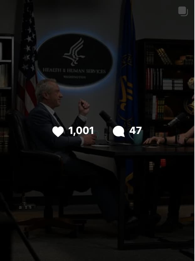 "Video thumbnail of Ben Greenfield interviewing a guest at a desk in front of a U.S. Department of Health and Human Services sign, with American and state flags visible in the background, showing 1,001 likes and 47 comments."