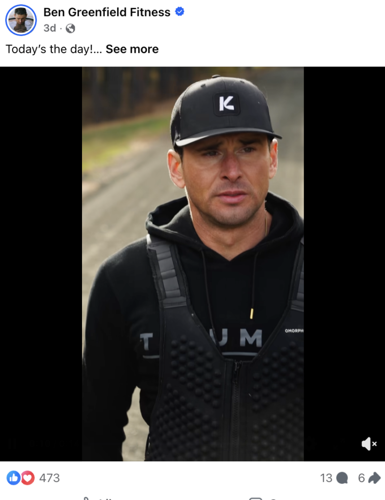 Ben Greenfield stands outdoors on a gravel path wearing a black weighted vest over a black hoodie with "TRIUMPH" and "OMORPH" visible on the fabric, paired with a black trucker cap featuring a white "K" logo. Facebook post from Ben Greenfield Fitness, verified page, posted 3 days ago, captioned "Today's the day!"
